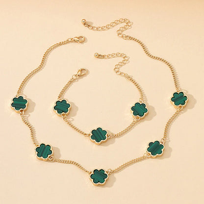 Gold-plated necklace and bracelet set with green clover flower charms